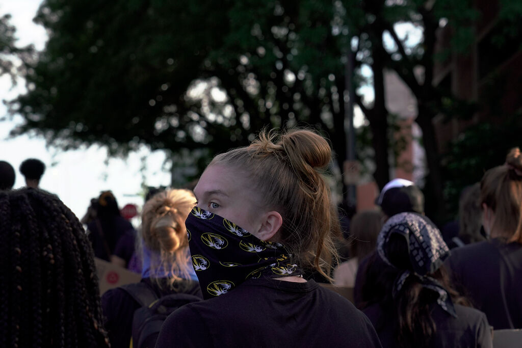 A marcher looks back down Tiger Ave. during the "March With Mizzou" protest on Wednesday